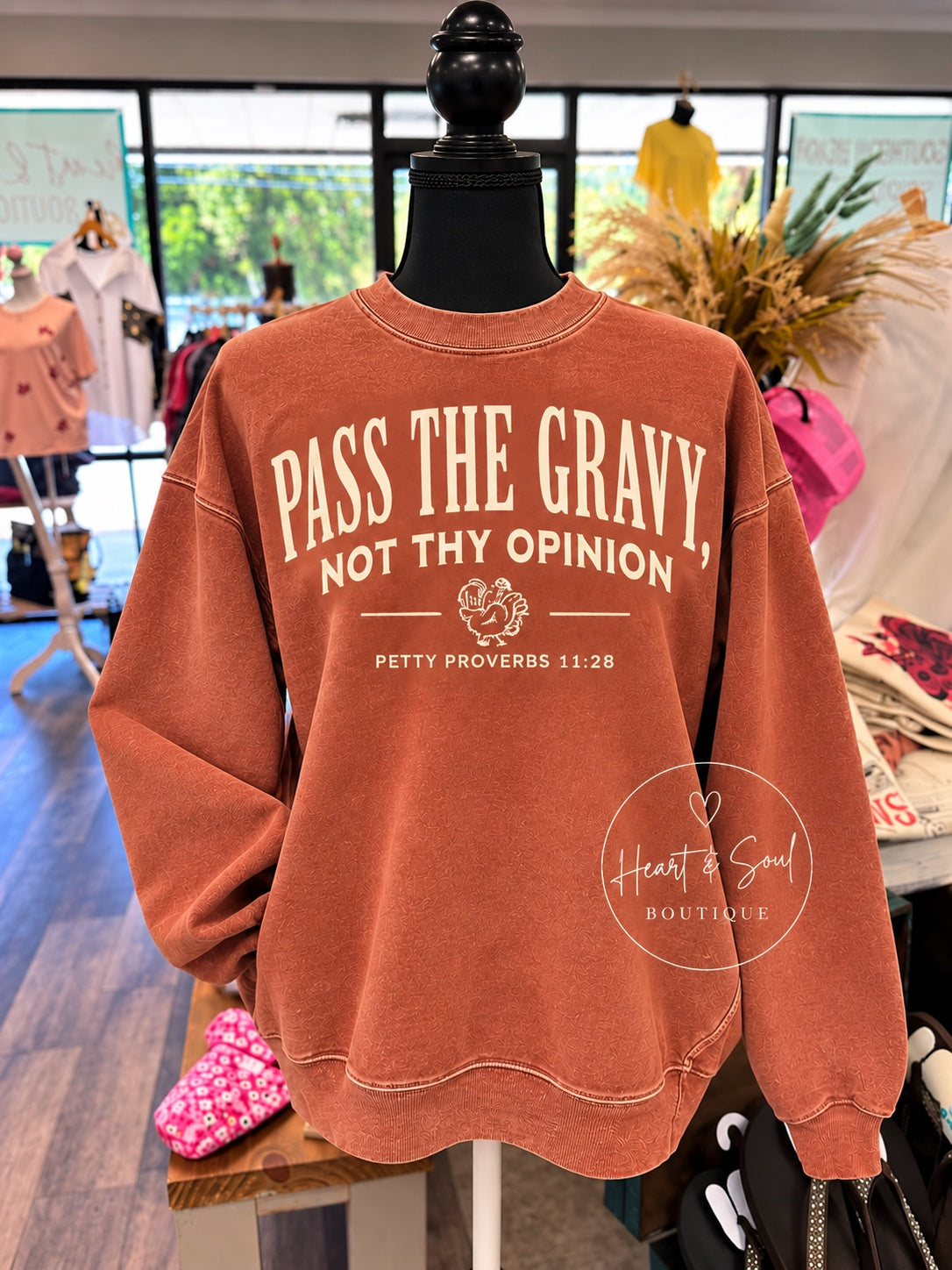 Terracotta Pass the Gravy sweatshirt on mannequin